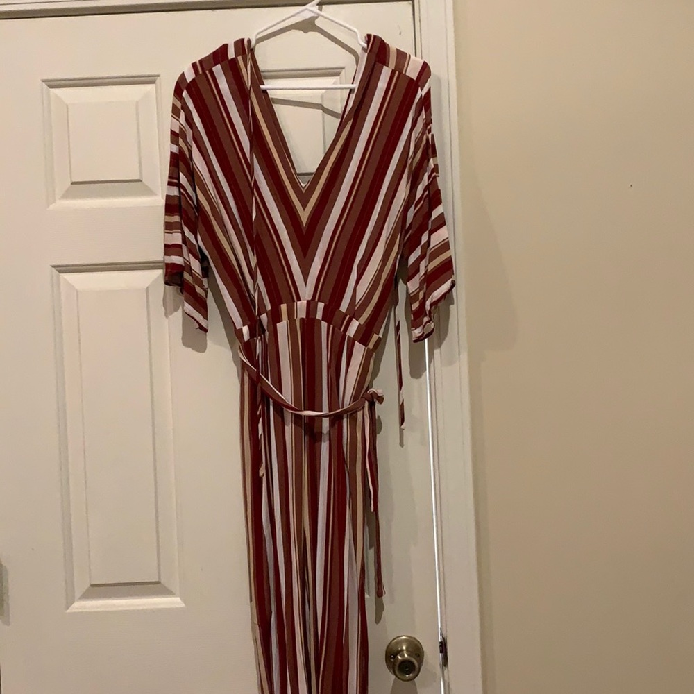 Deep V neck jumpsuit. Pants are crop comes right above ankle.